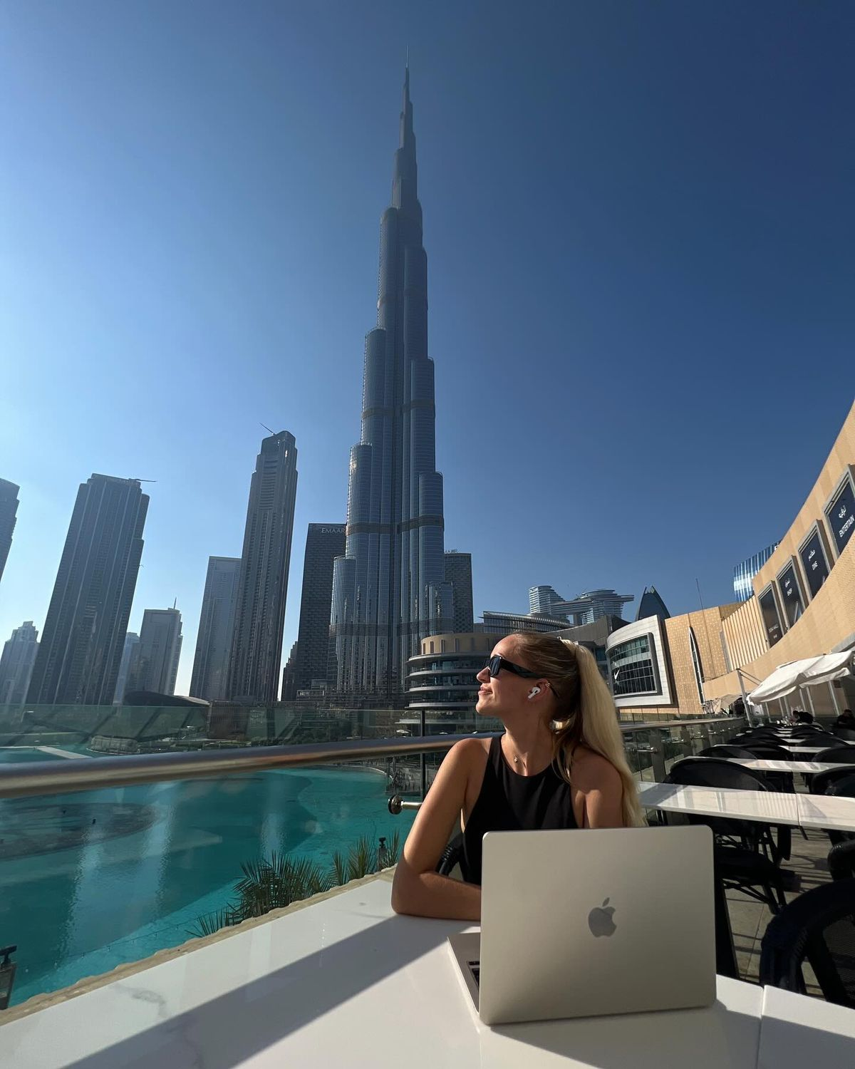 Entrepreneur working remotely on a laptop overlooking a modern city skyline